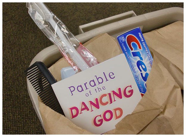 closeup of paper bag, showing booket "Parable of the Dancing God"