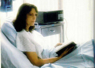Woman reading Bible in hospital bed