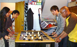four people playing foosball